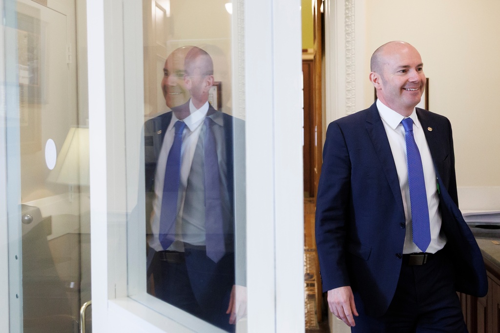 Sen. Mike Lee, R-Utah, walks to the Senate television studio before speaking about the SAVE Act on Capitol Hill on Thursday, March 19, 2026, in Washington. (AP Photo/Tom Brenner)