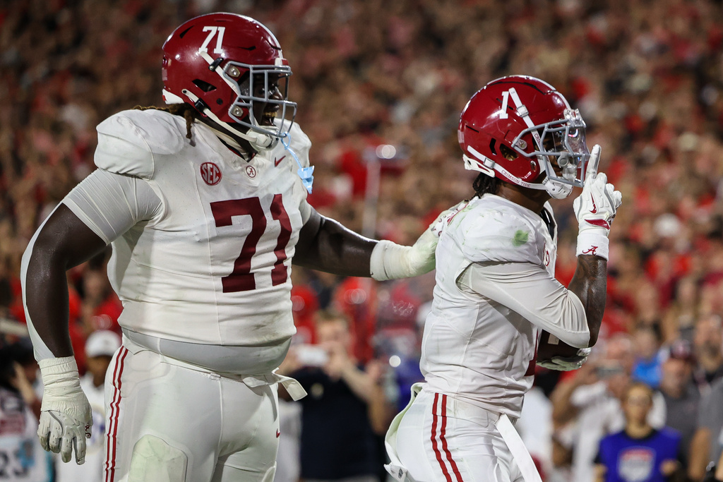 Alabama offensive lineman Kam Dewberry (71) and wide receiver Isaiah Horton (1) react after Horton's touchdown reception in the first half of an NCAA college football game against Georgia, Saturday, Sept. 27, 2025, in Athens, Ga. (AP Photo/Colin Hubbard)