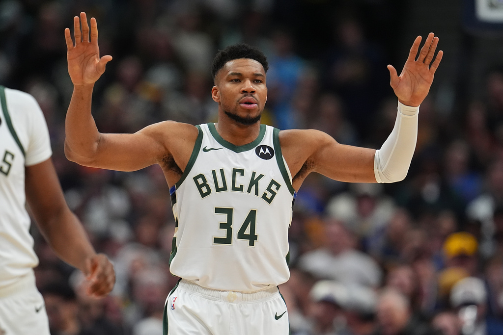 Milwaukee Bucks forward Giannis Antetokounmpo looks for direction from the bench in the first half of an NBA basketball game against the Denver Nuggets, Sunday, Jan. 11, 2026, in Denver. (AP Photo/David Zalubowski)