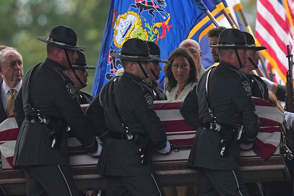Pall bearers carry the coffin of a slain officer during funeral services for Northern York County Regional Police detectives Cody Michael Becker, Mark Edward Baker and Isaiah Emenheiser, Thursday, Sept. 25, 2025, in Red Lion, Pa. (AP Photo/Matt Rourke)