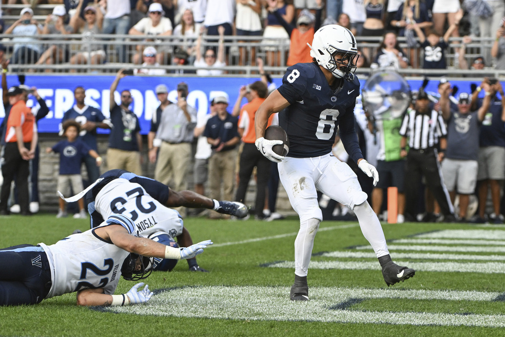 Penn State wide receiver Trebor Pena (8) scores a touchdown in front of Villanova defensive back Christian Sapp (22) during the second quarter of an NCAA college football game, Saturday, Sept. 13, 2025, in State College, Pa. (AP Photo/Barry Reeger)