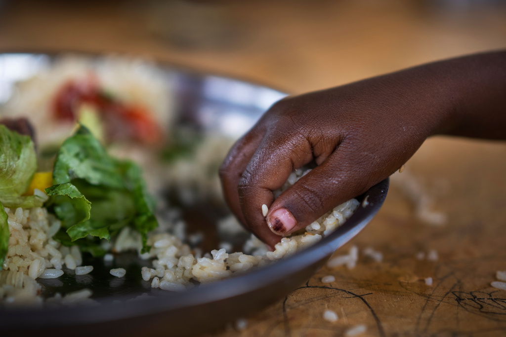 FILE - A girl eats at a school in Dollow, Somalia, Sept. 19, 2022. (AP Photo/Jerome Delay, file)