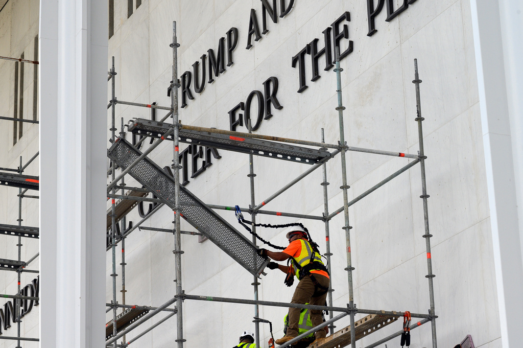 Workers erect scaffolding in front of the John F. Kennedy Center for the Performing Arts sign in Washington, Friday, June 12, 2026. (AP Photo/Cliff Owen)