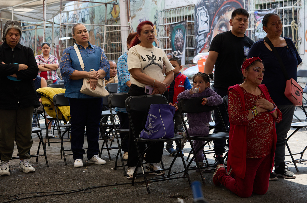 Parishioners pray to a giant Baby Jesus in Mexico City, Tuesday, March 10, 2026. (AP Photo/Ginnette Riquelme)