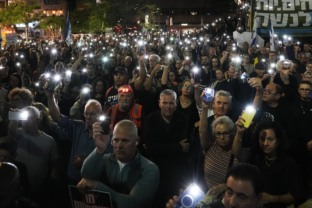 People take part in a protest against Prime Minister Benjamin Netanyahu's government and call for a state commission of inquiry to investigate the events of the Hamas militant group attack of October 7, 2023, as they gather at Habima square, in Tel Aviv, Israel, Saturday, Nov. 15, 2025. (AP Photo/Mahmoud Illean)