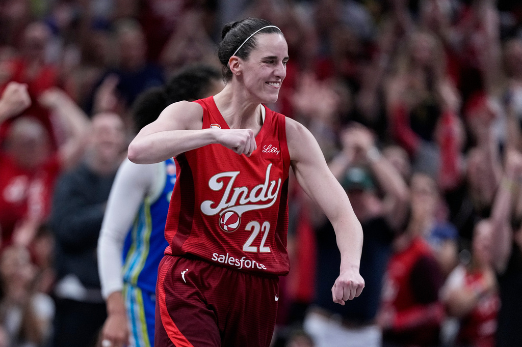 Indiana Fever guard Caitlin Clark celebrates after a 3-point basket against the Dallas Wings in the second half of a WNBA basketball game in Indianapolis, Friday, Aug. 14, 2026. (AP Photo/Michael Conroy)