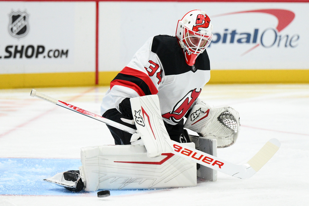 New Jersey Devils goaltender Jake Allen blocks the puck during the first period of an NHL hockey game against the Washington Capitals, Saturday, Nov. 15, 2025, in Washington. (AP Photo/Nick Wass)