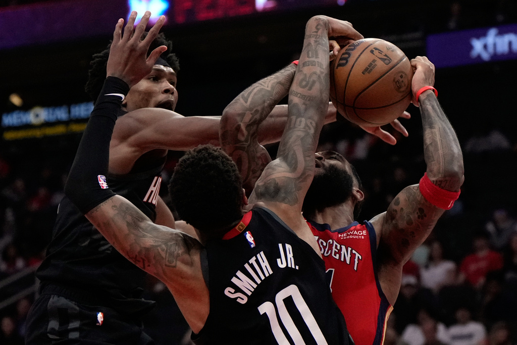 Houston Rockets guard Amen Thompson (1) and forward Jabari Smith Jr. (10) defend against New Orleans Pelicans guard Saddiq Bey during the first half of an NBA basketball game in Houston, Friday, March 13, 2026. (AP Photo/Ashley Landis)