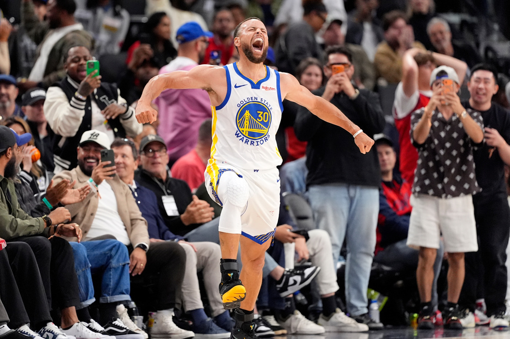 Golden State Warriors guard Stephen Curry celebrates after scoring during the second half of an NBA play-in tournament basketball game against the LA Clippers, Wednesday, April 15, 2026, in Inglewood, Calif. (AP Photo/Mark J. Terrill)