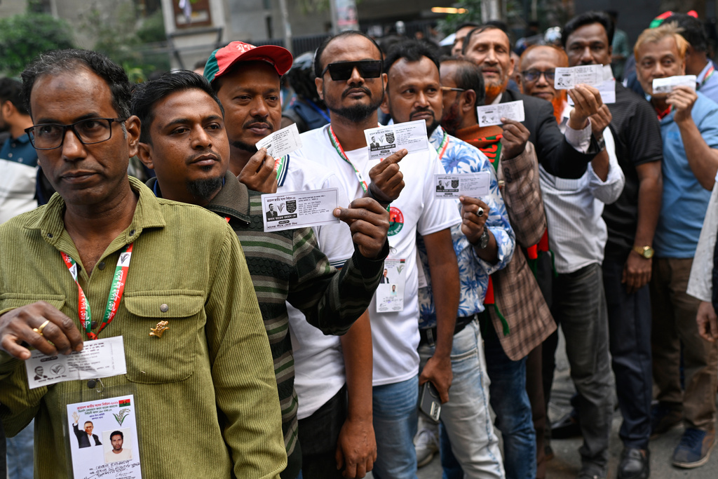Voters wait in line outside a polling center to cast their ballots during the national parliamentary elections in Dhaka, Bangladesh, Thursday, Feb. 12, 2026. (AP Photo/Mahmud Hossain Opu)