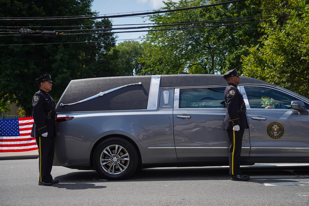 NYPD officers stand next to a hearse carrying fallen U.S. Army Sgt. Angel Sarah Rampersad, who was killed in the ongoing war between the U.S. and Iran, during the funeral procession in the Queens borough of New York on Friday, July 31, 2026. (AP Photo/Ryan Murphy) ADDITION: Prepends Angel to full name