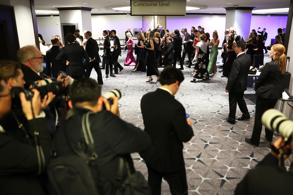 Guest evacuate after an incident at the White House Correspondents Dinner, Saturday, April 25, 2026, in Washington. (AP Photo/Tom Brenner)