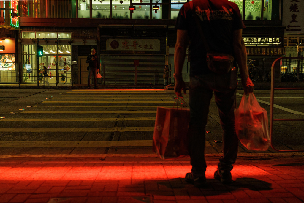 Pedestrians wait at a traffic light crossing during the Lunar New Year in Hong Kong, Feb. 18, 2026. (AP Photo/May James)