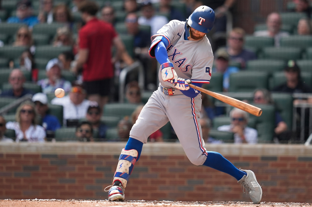 Texas Rangers' Brandon Nimmo (24) hits an RBI-Single in the third inning of a baseball game against the Atlanta Braves, Saturday, July 18, 2026, in Atlanta. (AP Photo/Mike Stewart)