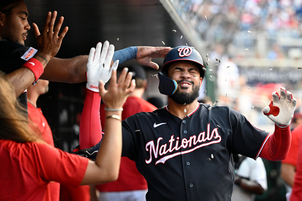 Washington Nationals' Luis García Jr. is greeted in the dugout after hitting a solo home run during the first inning of a baseball gamea gainst the Pittsburgh Pirates, Friday, July 3, 2026, in Washington. (AP Photo/John McDonnell)