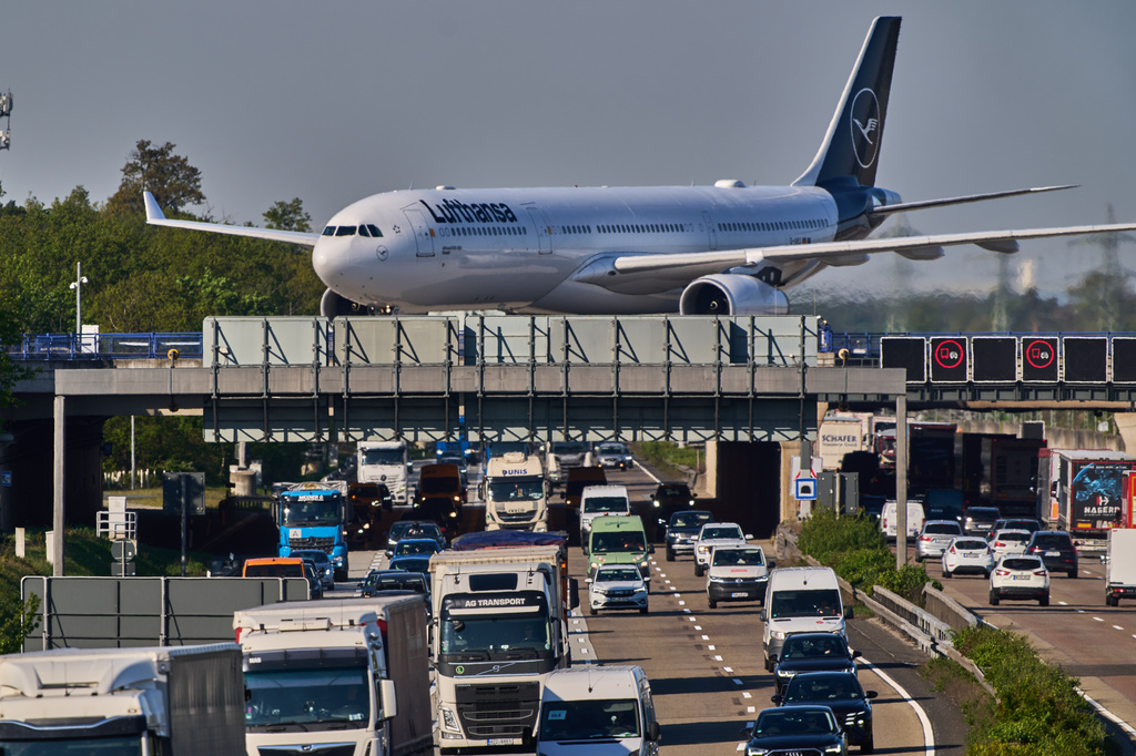 A Lufthansa aircraft rolls on a bridge over a highway at the airport in Frankfurt, Germany, Wednesday, April 22, 2026. (AP Photo/Michael Probst)
