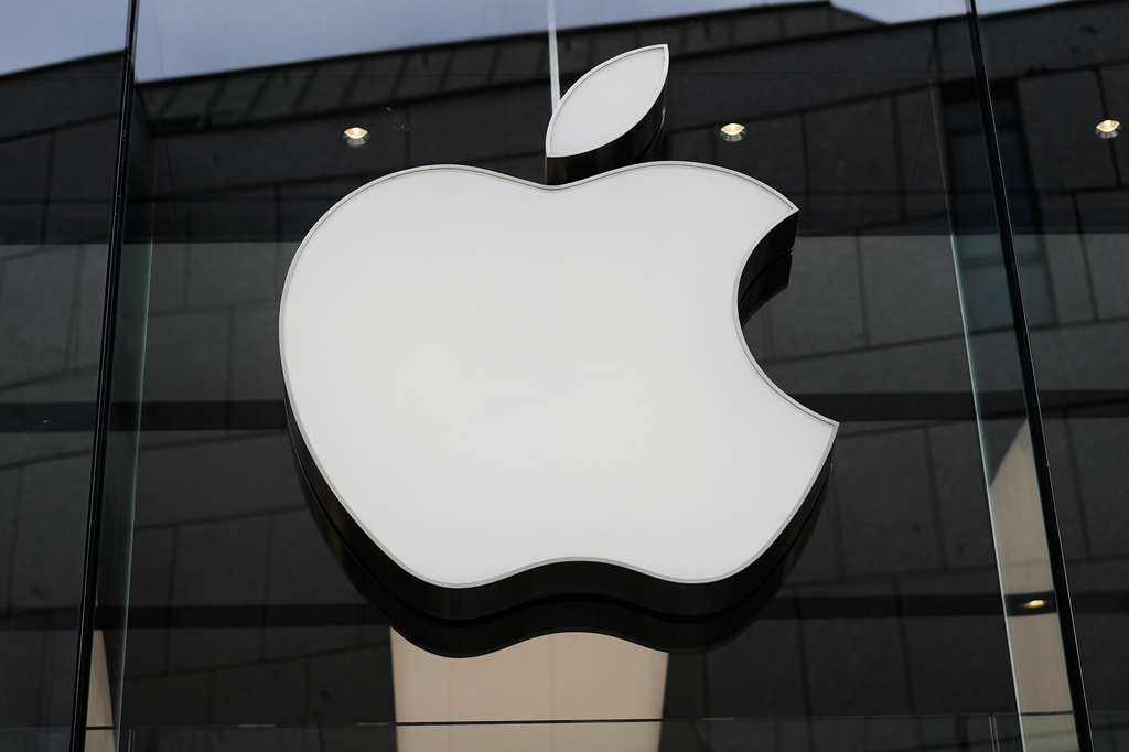 FILE - The Apple logo is illuminated at a store in Munich, Germany, April 2, 2026. (AP Photo/Matthias Schrader, File)