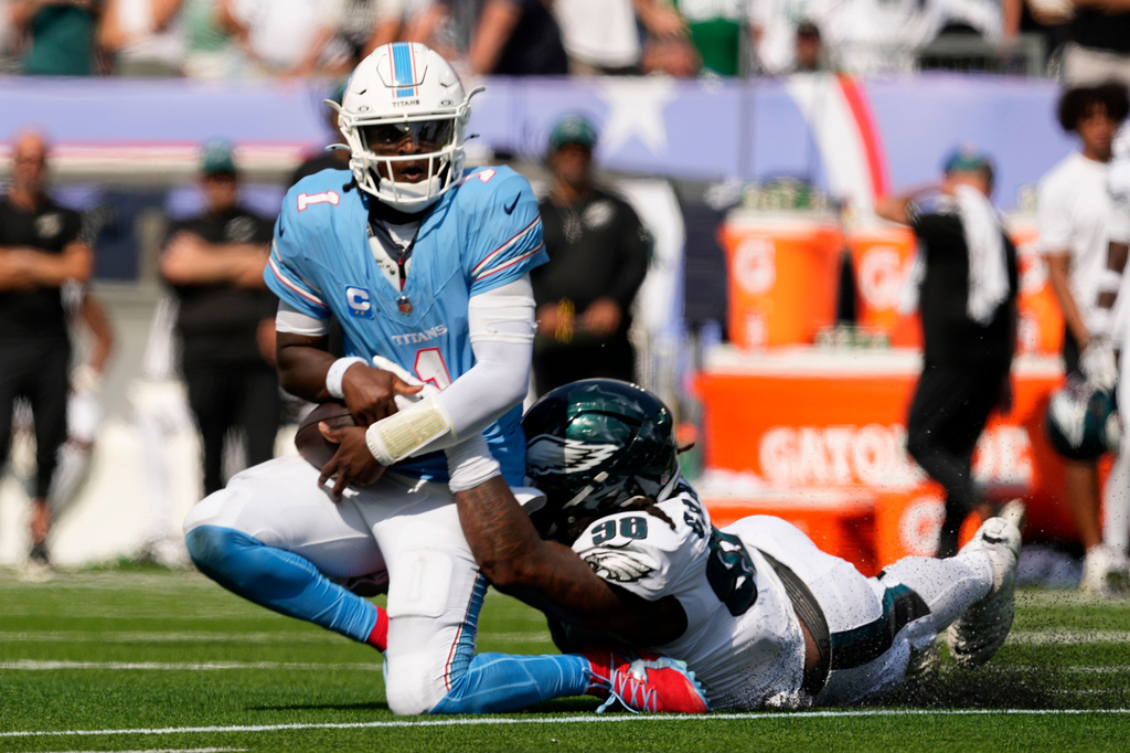 Tennessee Titans quarterback Cam Ward (1) is sacked by Philadelphia Eagles defensive tackle Jalen Carter (98) during the second half of an NFL football game, Sunday, Sept. 20, 2026, in Nashville, Tenn.(AP Photo/George Walker IV)