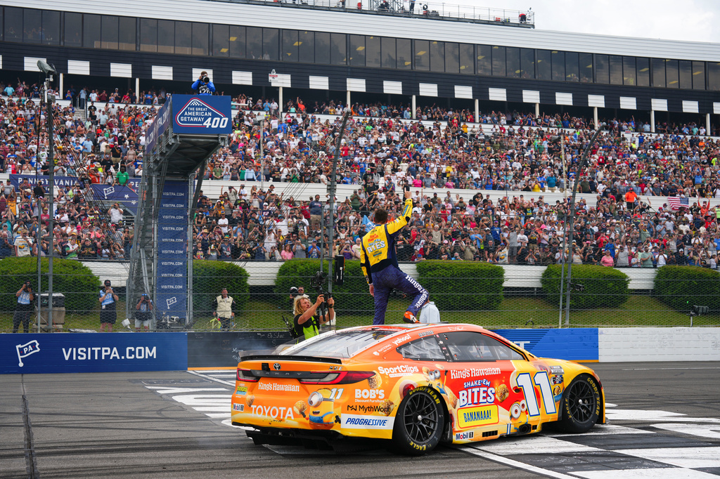 Denny Hamlin celebrates his win during a NASCAR Cup Series auto race at Pocono Raceway, Sunday, June 14, 2026, in Long Pond, Pa. (AP Photo/Derik Hamilton)