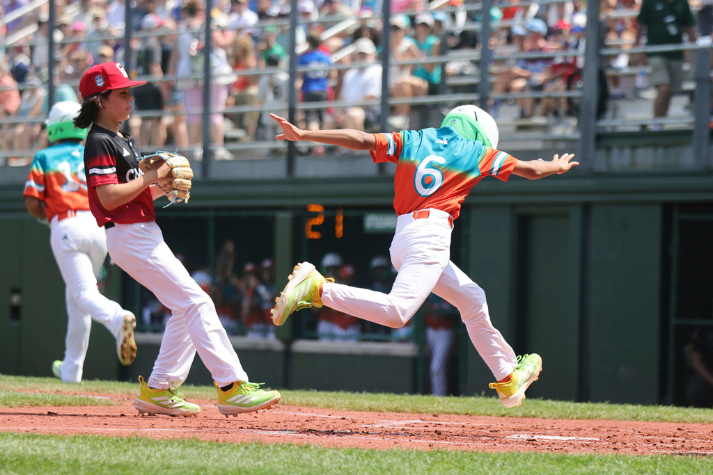 Venezuela's Sebastian Lopez crosses home to score against Canada during the first inning of a baseball game at the Little League World Series, Friday, Aug. 15, 2025, in South Williamsport, Pa. (AP Photo/Jared Freed)