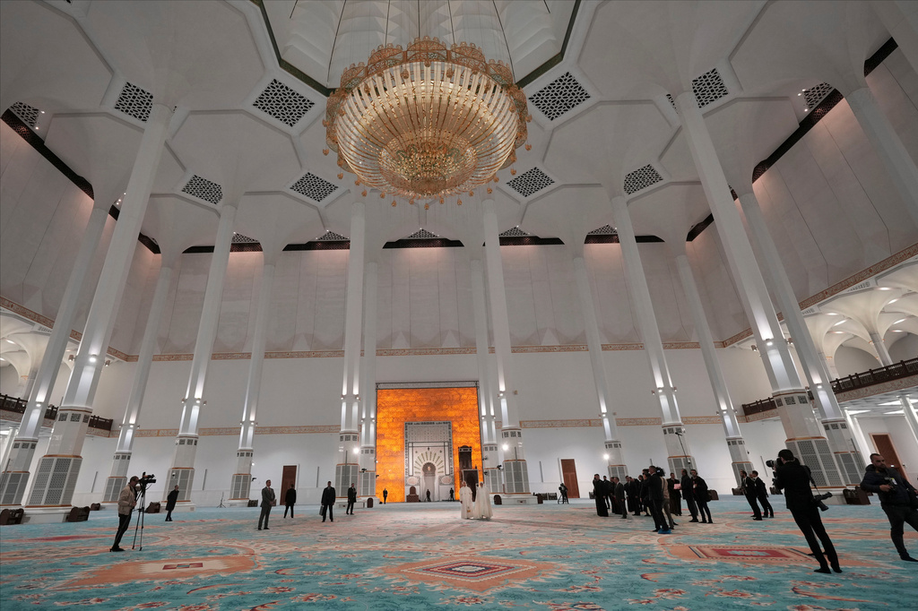 Pope Leo XIV is welcomed by Rector Mohamed Mamoun Al Qasimi upon his arrival at the Great Mosque in Algiers, Monday, April 13, 2026, on the first day of an 11-day apostolic journey to Africa. (AP Photo/Andrew Medichini)