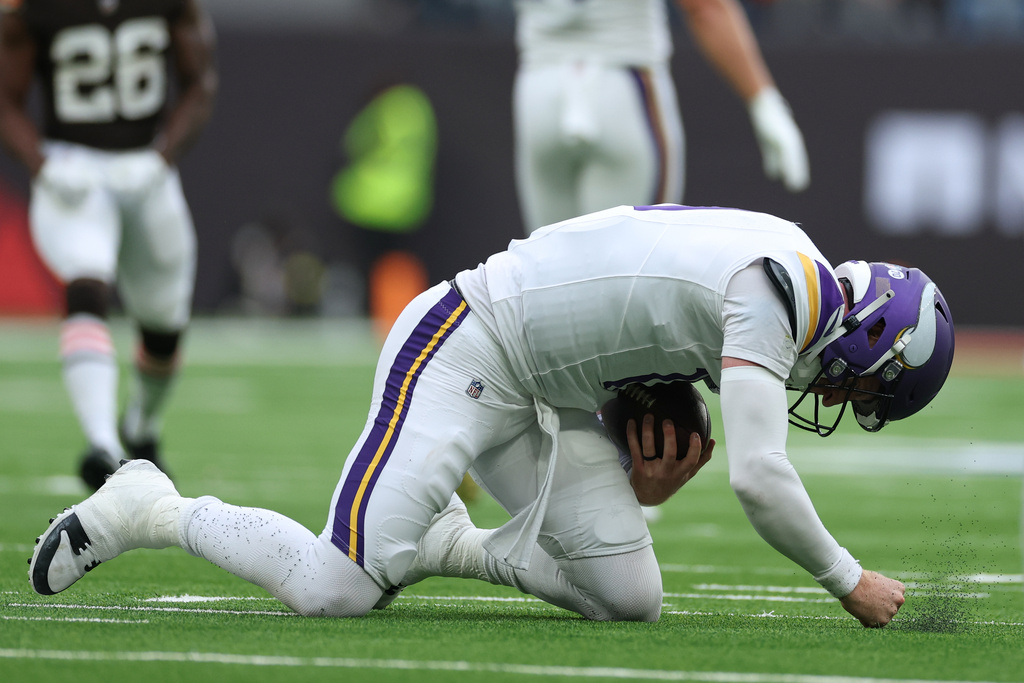Minnesota Vikings quarterback Carson Wentz (11) punches the field after he was sacked by Cleveland Browns defensive tackle Maliek Collins (96) during the second half of the NFL game between Minnesota Vikings and Cleveland Browns at the Tottenham Hotspur stadium in London, Sunday, Oct. 5, 2025. (AP Photo/Ian Walton)