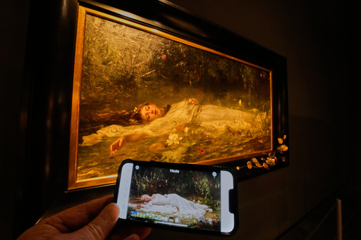 The opening part of Taylor Swift's video "The Fate of Ophelia" is displayed on a mobile phone in a museum showing a painting by Art Nouveau painter Friedrich Heyser showing Ophelia, a Shakespeare Character, in Wiesbaden, Germany, Thursday, Oct. 16, 2025. (AP Photo/Michael Probst) The opening part of Taylor Swift's video "The Fate of Ophelia" is displayed on a mobile phone in a museum showing a painting by Art Nouveau painter Friedrich Heyser showing Ophelia, a Shakespeare Character, in Wiesbaden, Germany, Thursday, Oct. 16, 2025. (AP Photo/Michael Probst)