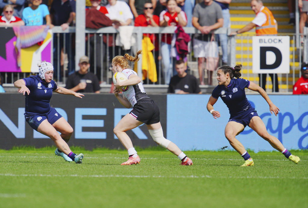 Canada's Paige Farries, center runs with the ball, during the Women's Rugby World Cup 2025 Pool B match between Scotland and Canada, at Sandy Park, in Exeter, England, Saturday, Sept. 6, 2025. (Ben Birchall/PA via AP)