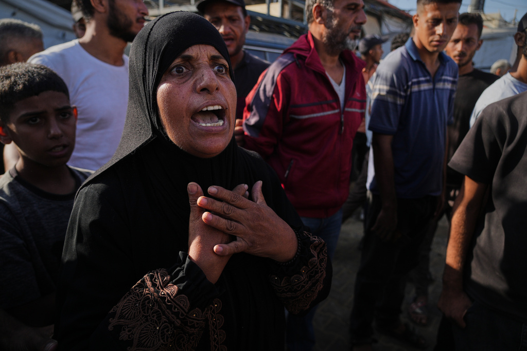 Palestinians mourn during the funeral of their relatives who were killed in an Israeli airstrike on Deir al-Balah, central Gaza Strip, Tuesday, Sept. 30, 2025. (AP Photo/Abdel Kareem Hana)