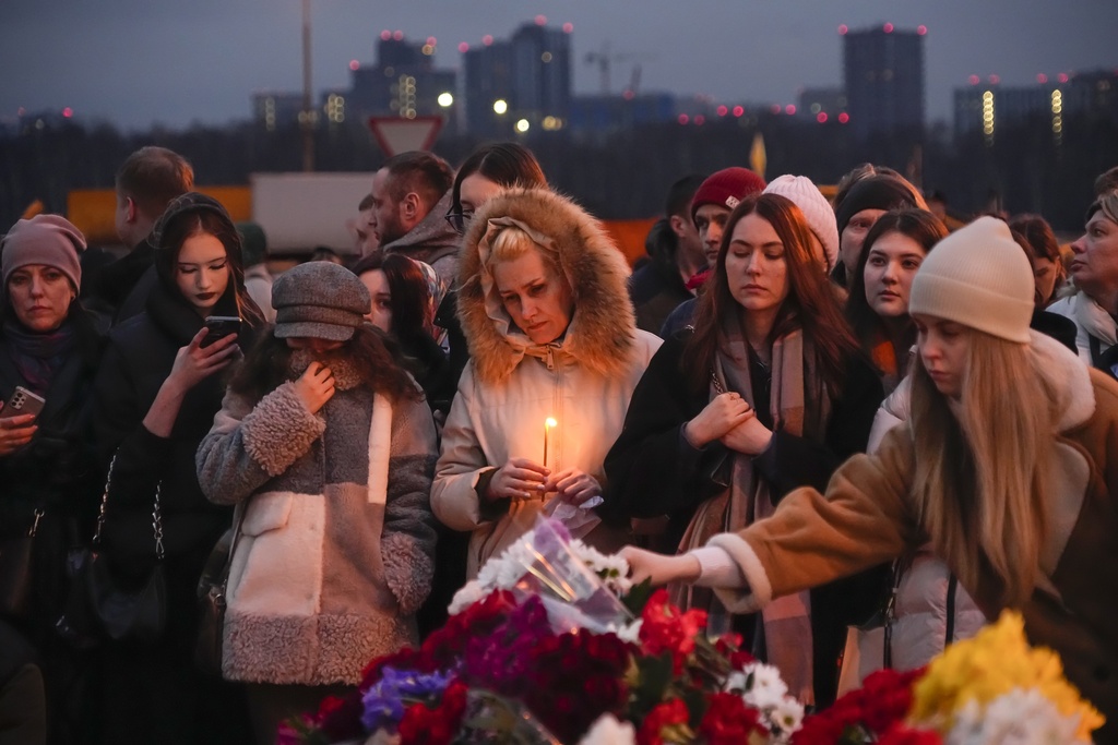 FILE - People lay flowers and light candles for victims of a mass shooting and arson attack at the Crocus City Hall concert venue on the western edge of Moscow, Russia, on March 23, 2024. (AP Photo/Alexander Zemlianichenko, File)
