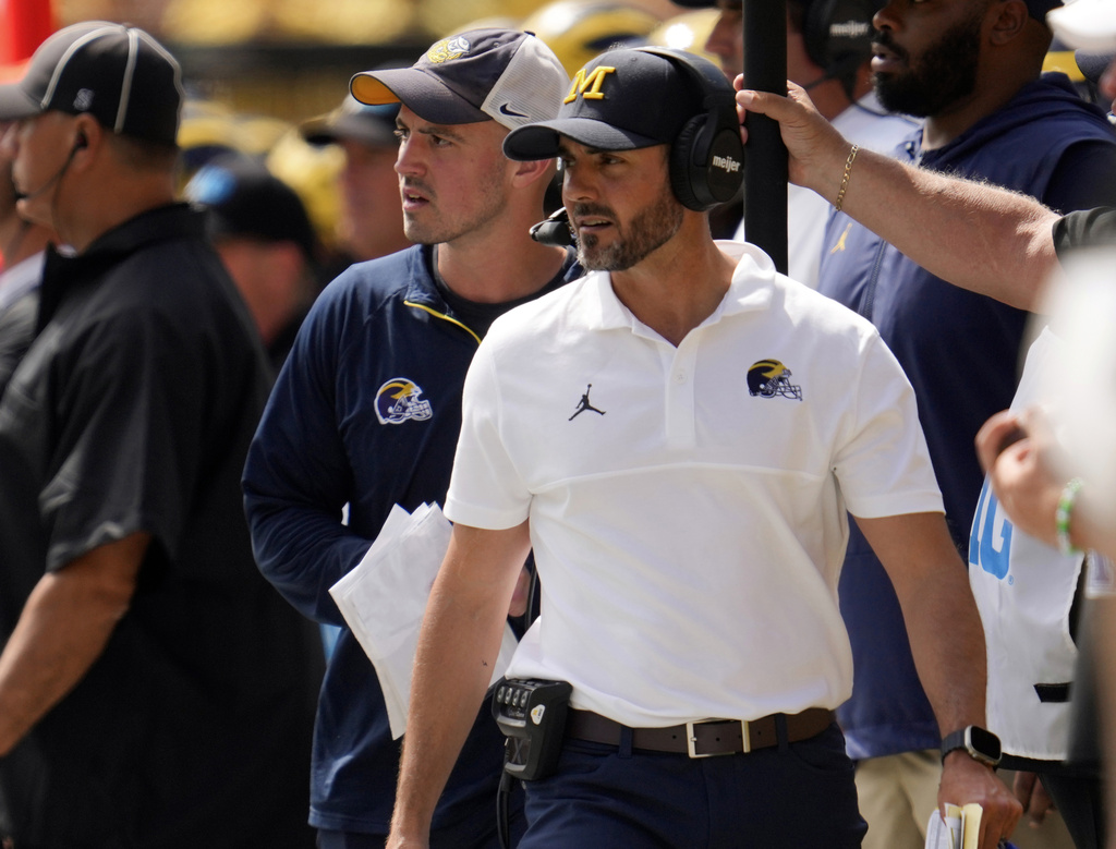 FILE - Michigan defensive coordinator Jesse Minter, center right, watches against East Carolina as analytics assistant Connor Stalions, center left, looks on during an NCAA college football game in Ann Arbor, Mich., Sept. 2, 2023. (AP Photo/Paul Sancya, file)
