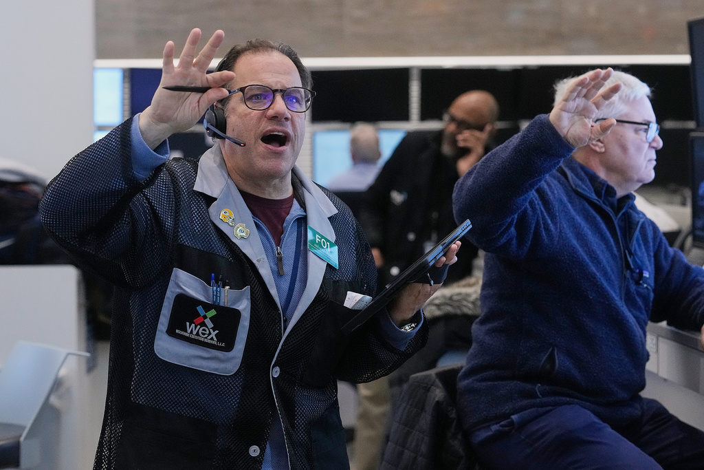 Anthony Spina, left, works with fellow options traders on the floor of the New York Stock Exchange, Wednesday, Jan. 28, 2026. (AP Photo/Richard Drew)