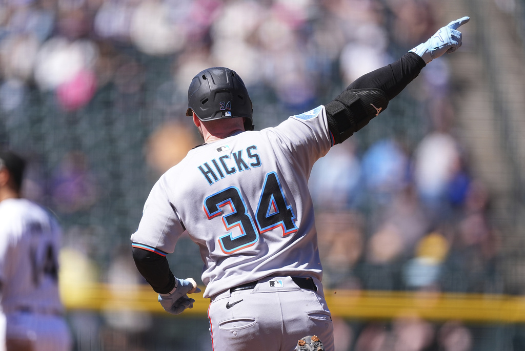 Miami Marlins' Liam Hicks gestures to the bullpen as he circles the bases after hitting a two-run home run off Colorado Rockies starting pitcher Tanner Gordon in the third inning of a baseball game Thursday, Sept. 18, 2025, in Denver. (AP Photo/David Zalubowski)