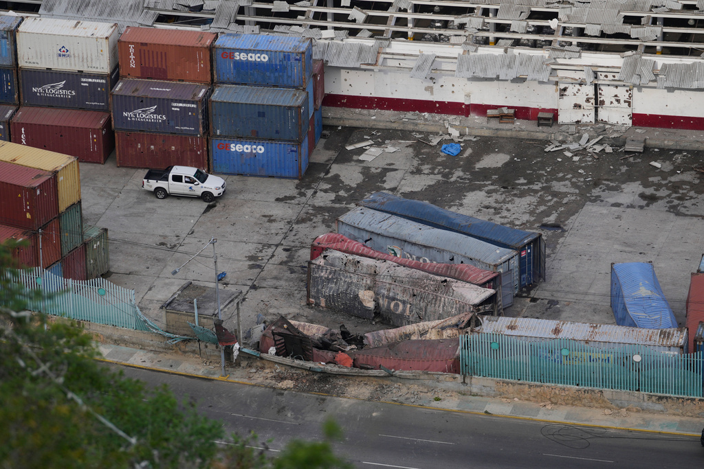 Destroyed containers lay at La Guaira port after explosions were heard in Venezuela, Saturday, Jan. 3, 2026. (AP Photo/Matias Delacroix)