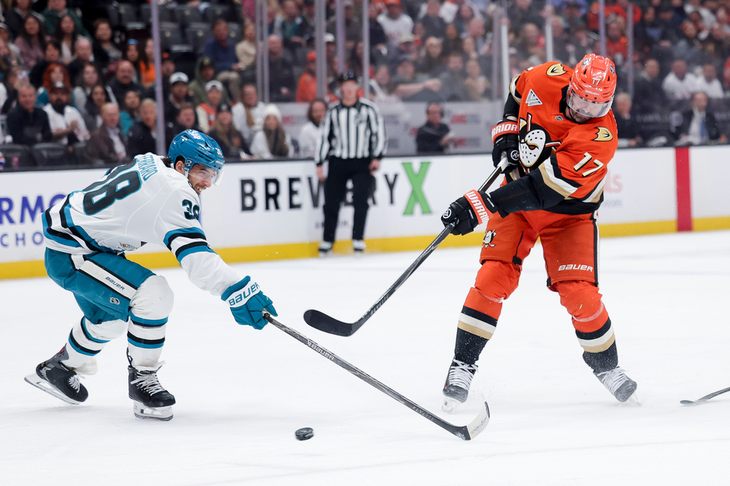 Anaheim Ducks left wing Alex Killorn, right, shoots against San Jose Sharks defenseman Mario Ferraro, left, during the first period of an NHL hockey game Thursday, April 9, 2026, in Anaheim, Calif. (AP Photo/Ryan Sun)