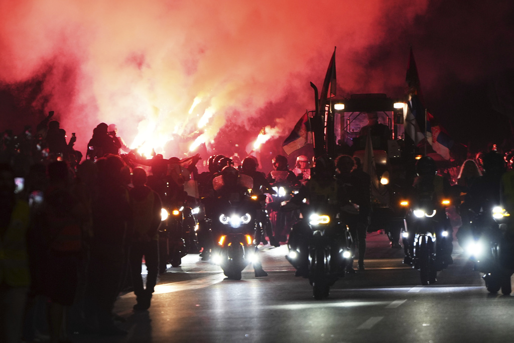 People welcome a group of students from southwestern town of Novi Pazar after marching to join a major rally marking the anniversary of a deadly train station disaster, in Novi Sad, Serbia, Friday, Oct. 31, 2025. (AP Photo/Darko Vojinovic)