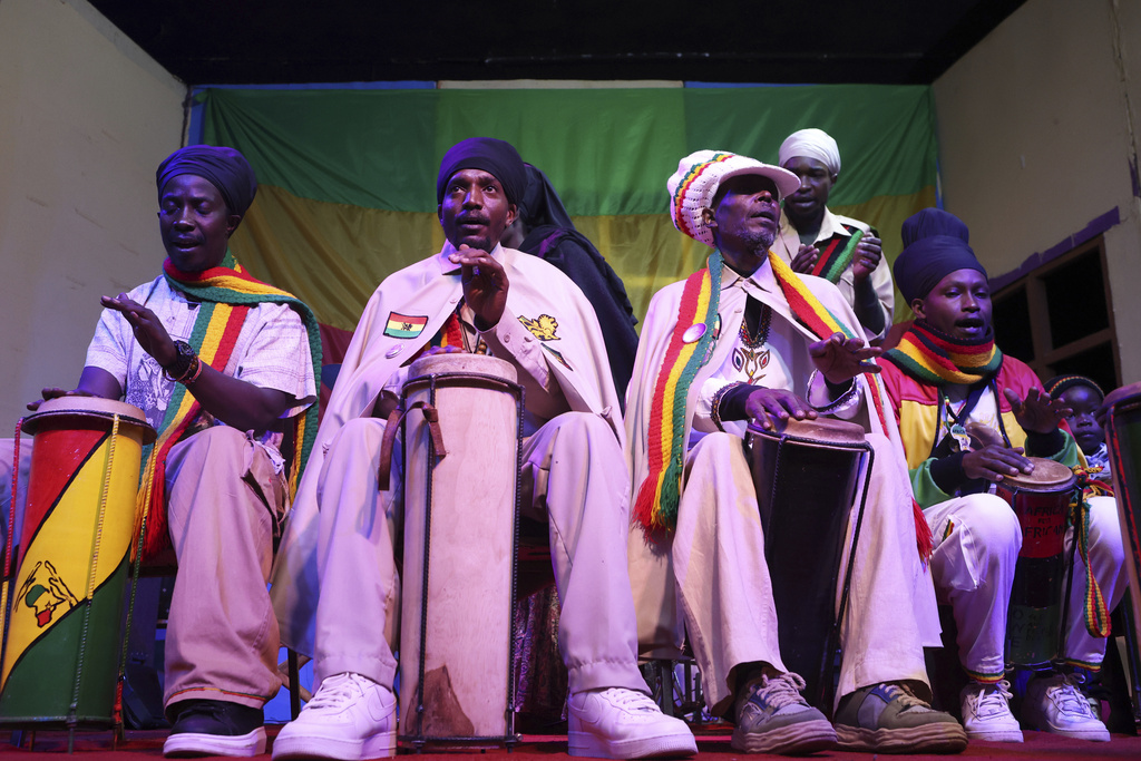 Members of the Rastafarian community play drums as others chant and sing during a celebration to mark 133 years since the birth of Haile Selassie I at the Kenya National Theatre in Nairobi, Kenya, Wednesday, July 23, 2025. (AP Photo/Andrew Kasuku)