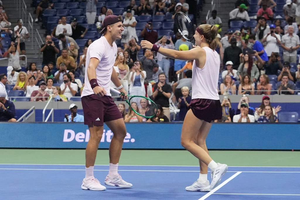 Jakub Mensik, of the Czech Republic, left celebrates with Karolina Muchova, of the Czech Republic, after they won the mixed doubles final match against Belinda Bencic, of Switzerland, and Flavio Cobolli, of Italy, at the U.S. Open tennis championships Wednesday, Aug. 26, 2026, in New York. (AP Photo/Frank Franklin II)