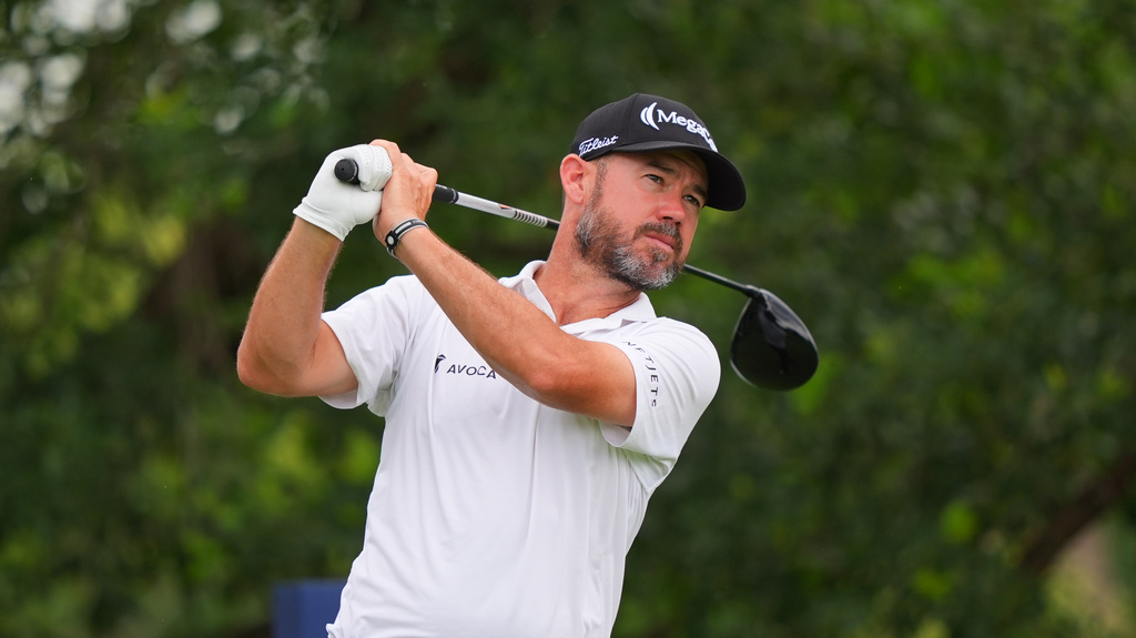 Brian Harman watches his tee shot on the ninth hole during the first round of the Charles Schwab Challenge golf tournament at Colonial Country Club in Fort Worth, Texas, Thursday, May 28, 2026. (AP Photo/LM Otero)