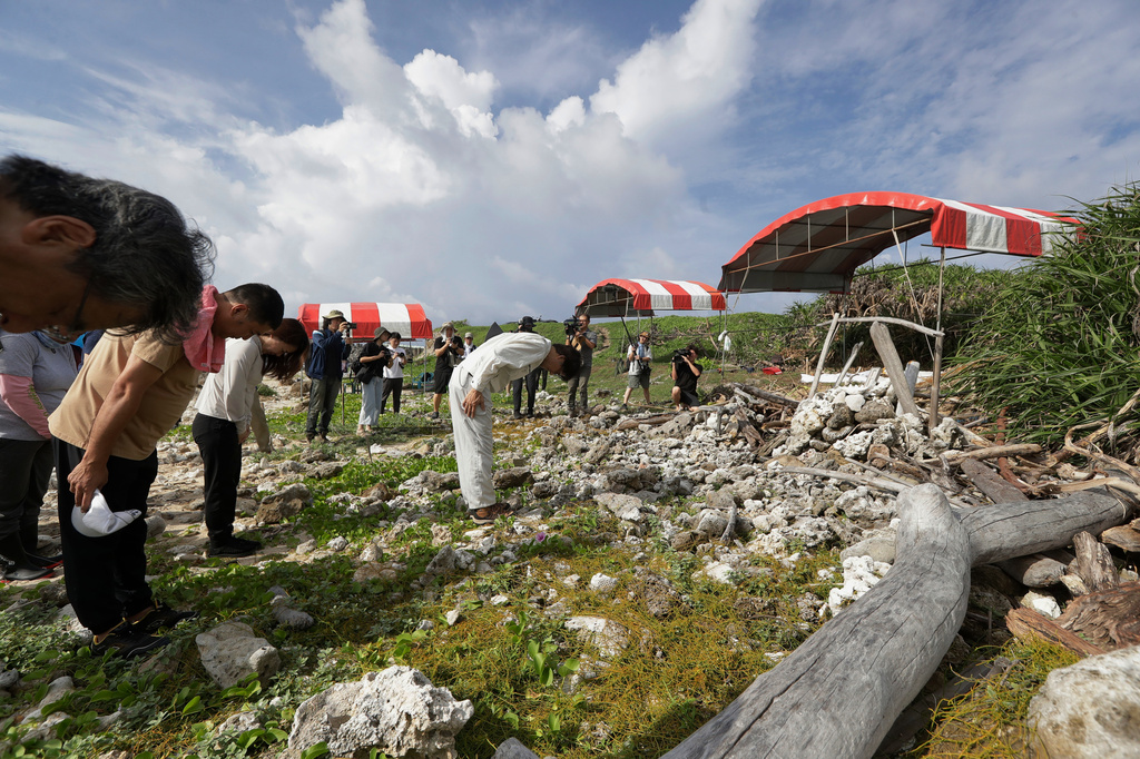 Tatsuaki Inoue, a member of the Japan Association for Recovery and Repatriation of War Casualties, leads volunteers to pay respects ahead of their excavation work to find remains of Japanese soldiers who died during WWII and washed ashore on the coastline of Hengchun township, Pingtung county, southern Taiwan, Monday, July 20, 2026. (AP Photo/Chiang Ying-ying)
