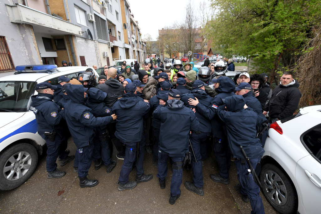 People clash with Serbian police officers during a local election, in Crvenka, small town located in the municipality of Kula, Serbia, Sunday, March 29, 2026. (AP Photo)
