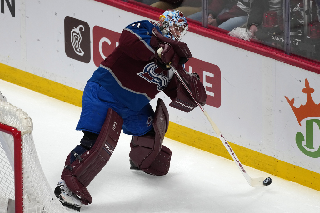 Colorado Avalanche goaltender Scott Wedgewood clears the puck from behind the net in the first period of Game 2 of an NHL hockey Stanley Cup second-round playoff series against the Minnesota Wild Tuesday, May 5, 2026, in Denver. (AP Photo/David Zalubowski)