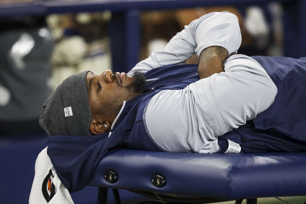 Dallas Cowboys defensive end Micah Parsons lies on the medical table during the second half of a preseason NFL football game against the Atlanta Falcons Friday, Aug. 22, 2025, in Arlington, Texas. (AP Photo/Gareth Patterson)