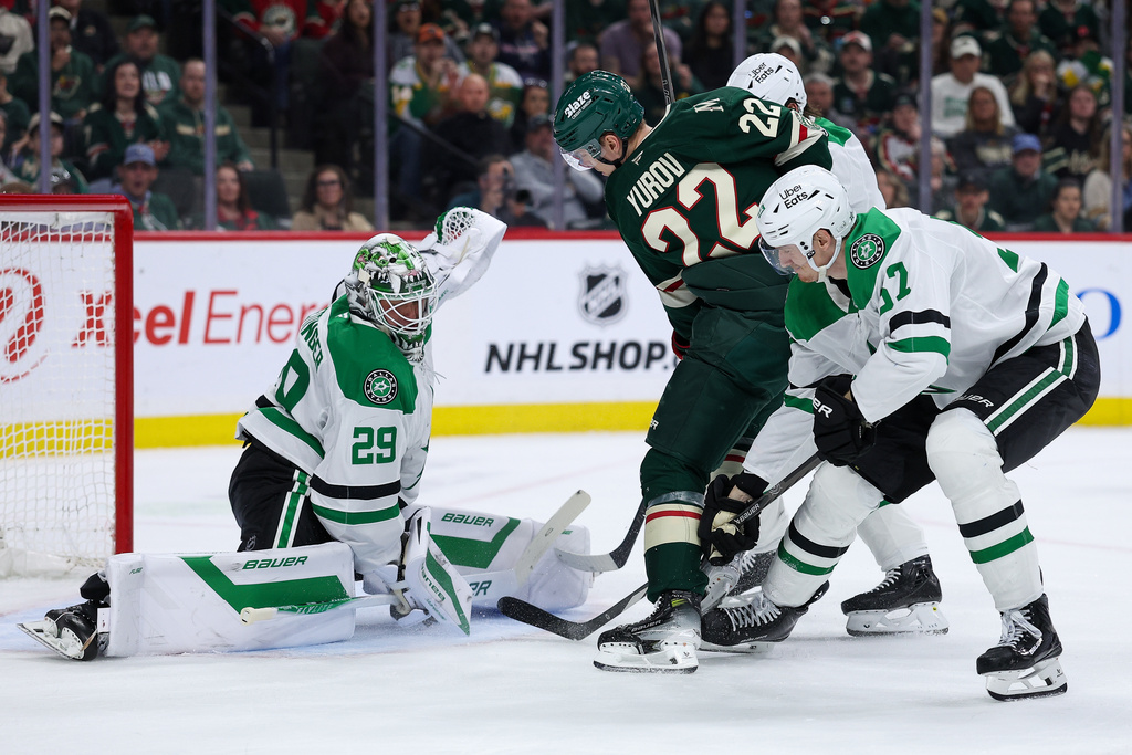 Dallas Stars goaltender Jake Oettinger (29) makes a save against a shot by Minnesota Wild right wing Danila Yurov (22) during the first period of an NHL hockey game Saturday, March 21, 2026, in St. Paul, Minn. (AP Photo/Matt Krohn)