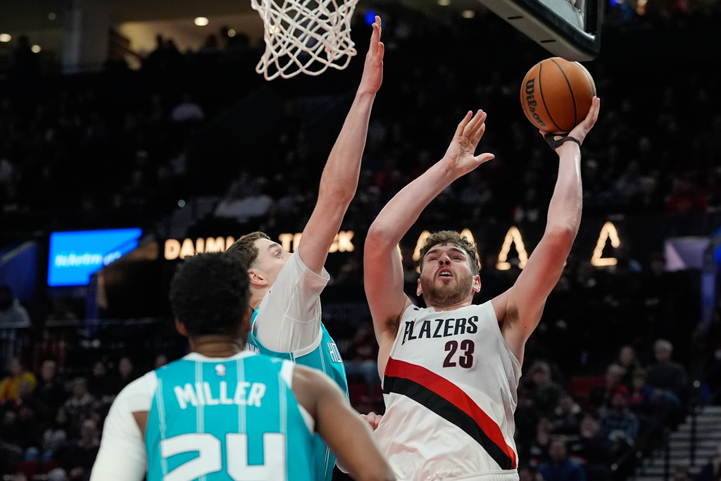 Portland Trail Blazers center Donovan Clingan (23) shoots during the first half of an NBA basketball game against the Charlotte Hornets, Tuesday, March 10, 2026, in Portland, Ore. (AP Photo/Jenny Kane)
