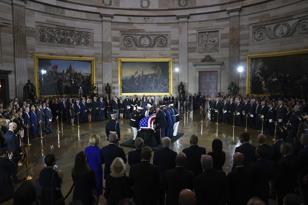 An Armed Forces Body Bearer Team places the flag-draped casket of Sen. Lindsey Graham of South Carolina, in the Rotunda of the U.S. Capitol, Tuesday, July 28, 2026, in Washington. (AP Photo/Allison Robbert)