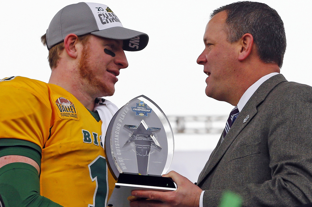 FILE - North Dakota State quarterback Carson Wentz receives the outstanding player trophy during the FCS championship NCAA college football game between North Dakota State and Jacksonville State, Jan. 9, 2016, in Frisco, Texas. (AP Photo/Mike Stone, File)