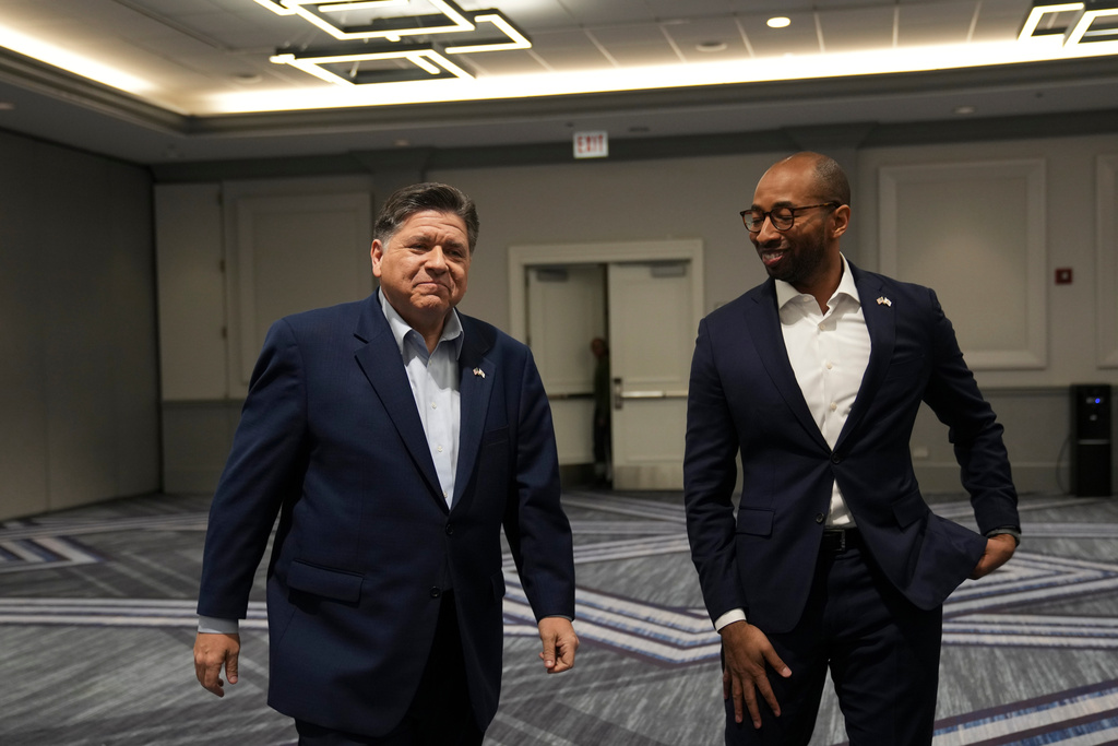 Illinois Gov. JB Pritzker, left, and running mate for lieutenant governor Christian Mitchell arrive for an interview, Wednesday, March 18, 2026, in Chicago. (AP Photo/Erin Hooley)