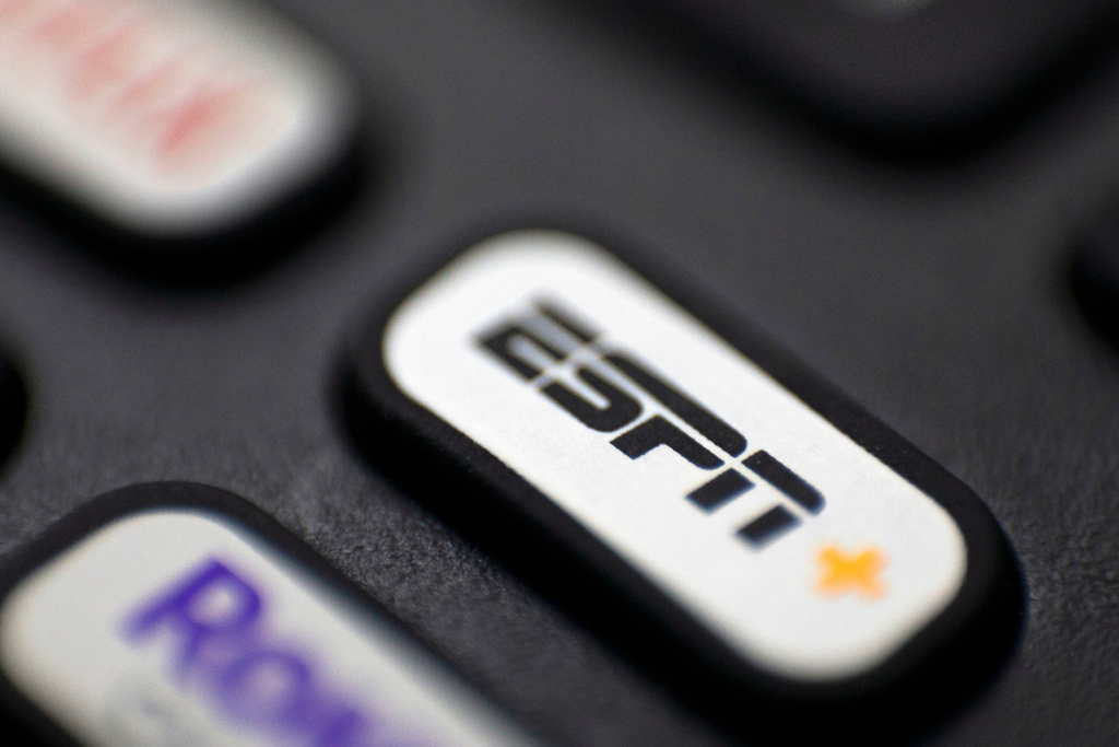 FILE — This Aug. 13, 2020 file photo shows a logo for ESPN on a remote control, in Portland, Ore. (AP Photo/Jenny Kane, FIle)