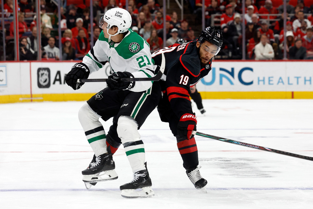 Carolina Hurricanes' K'andre Miller (19) collides with Dallas Stars' Jason Robertson (21) during the first period of an NHL hockey game in Raleigh, N.C., Tuesday, Jan. 6, 2026. (AP Photo/Karl DeBlaker)